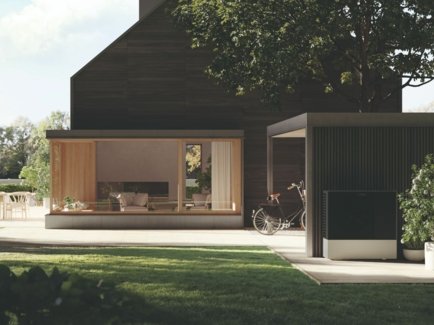 Luft-Wasser-Wärmepumpe von Viessmann - zu sehen ist ein modernes Haus mit einer zukunftsfähiger Wärmepumpenheizung; im Vordergrund ist die Außeneinheit der Wärmepumpe zu sehen.